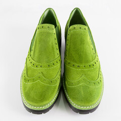 Female green leather shoes pares on white background, isolated product.