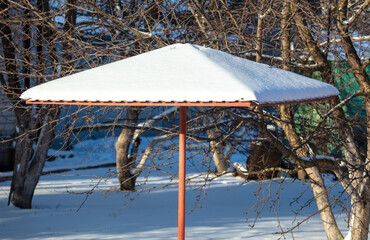 The roof of the gazebo in the snow in winter.