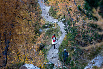 Naklejka premium Active Senior Couple on an Autumn Mountain Trail Hiking
