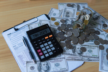 Tax 2023. Word Tax 2023 on calculator. Business and tax concept .Calculator, currency, dollar bills...
