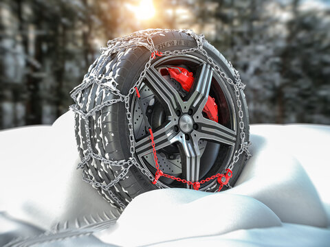 Car wheel with winter tire and snow chain in snow forest.