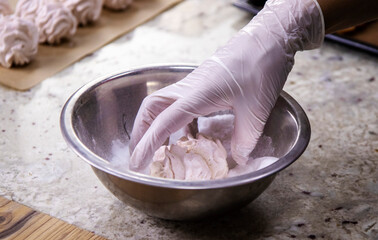 The pastry chef's hand in close-up. Fragrant and fresh marshmallows made from natural ingredients . The concept of delicious and healthy desserts