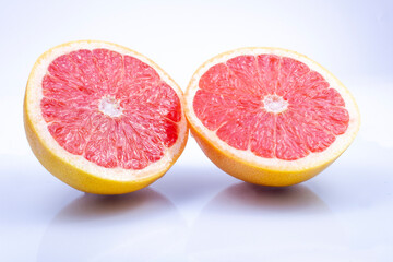 juicy, fresh red grapefruit on a grey, two halves of the fruit