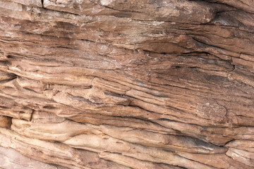 Naklejka na ściany i meble Ancient rock layers. Rock geology formation. Brown stone texture background