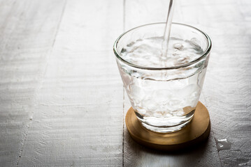 Glasses of water on a wooden table