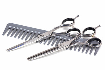 a hairdresser's tool scissors, comb on white background	