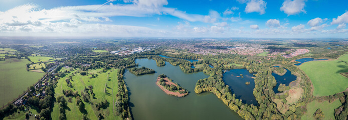 Beautiful aerial view of the Dinton Pastures Country Park, Black and White Swan Lake, and Winnersh Triangle
