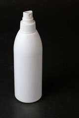 Plastic aerosol spray white bottle on dark background