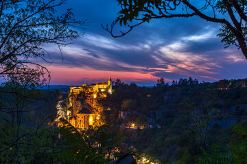 Panoramic view of Rocamadour illuminated at night, one of the most visited villages in France. Perfect setting for Halloween