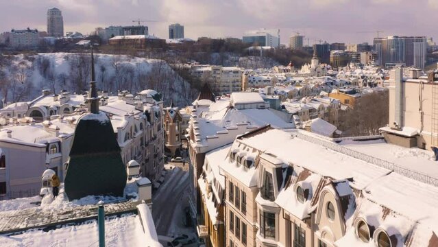 Urban winter city scape after heavy snowfall. Building roofs covered with snow.