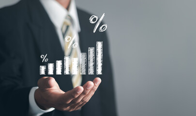 Concept of financial interest rates and mortgage rates. Businessman showing percentage icon with graph indicator. Interest rate, stocks, financial, ranking, mortgage rates.