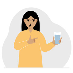 A woman holds a glass of water in his hand. The concept of water balance and health.