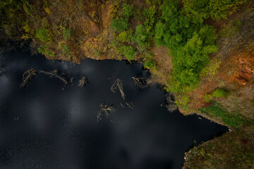 Beautiful view of the lake with black water and autumn forest