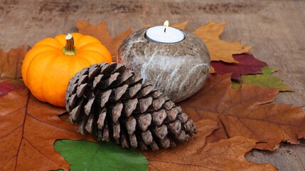 Candle, autumn leaves, pine cone and pumpkin . Autumn decoration. Concept for All Saints' Day, All Souls' Day, Deepest Sympathy...