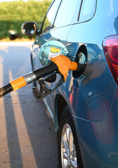 Filling the car with gasoline at gas station.