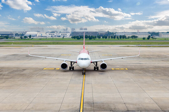 Airplane taxi in taxiway after landing and prepare to park in passenger gate.