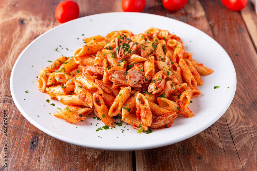 Poster Pasta with tuna in tomato sauce, typical food of Mediterranean Italian cuisine.