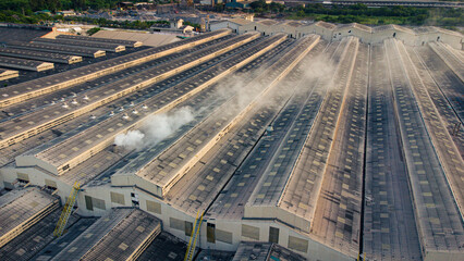 Toxic fumes spread from the roof of an industrial plant. Industrial plants emit large amounts of smoke from the factories during production. which creates air pollution for the world.