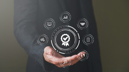 Businessman show thumbs up with icon that show top service quality standard in business or industrial ISO certification. Quality assurance formal concept in organization.