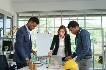 business engineer,architecture stressful meeting with home model in the office room, multiracial business people discussing a new real estate project