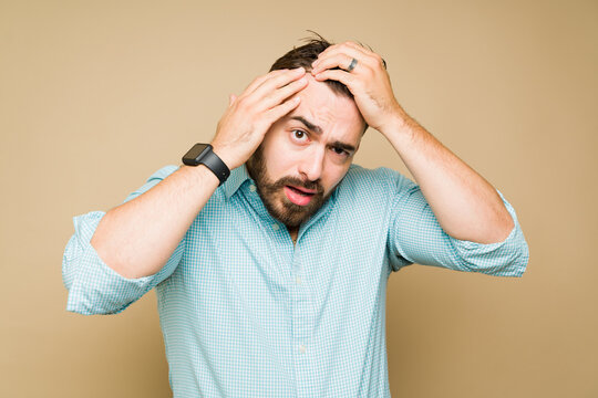 Stressed Man Looking At His Hairline