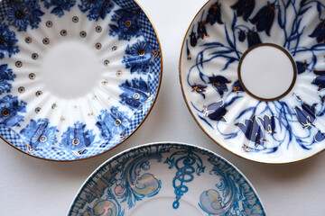 Vintage plates with blue drawings on a white background, top view