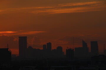 Fototapeta na wymiar orange golden sunset clear sky background with town city view 