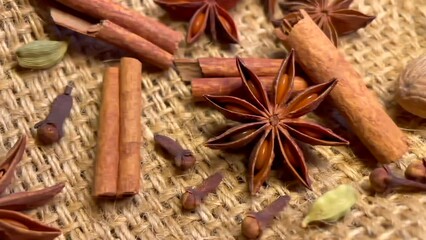 Aromatic spices collection on sackcloth, Christmas vibes. Ingredients for mulled wine. Anise stars, cardamom, cinnamon sticks, nutmeg, clove aromatic flower buds for mulled wine cooking at home. - Powered by Adobe