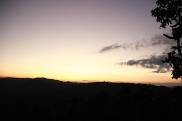 twilight evening time sunset sky background with mountain forest view 