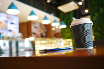 take away paper coffee cup o on cafe table