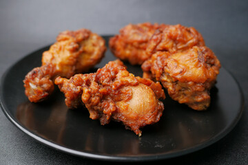  fried chicken fillets on plate on black background 