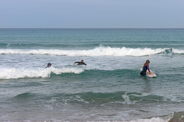 Surfers enter the sea
