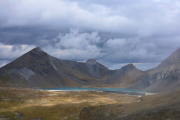 Limmerensee reservoir surrounded by Muttenchopf mountain and Muttsee mountain lake in Glarus, Switzerland