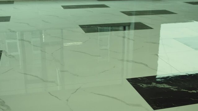 Big flooring tiles installed in beautiful home, tiles are made of ceramic material and with marmoreal textures . Granite or Marble floor . 