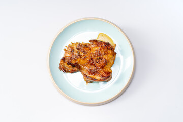 Fresh pan-fried chicken chops on a monochrome background