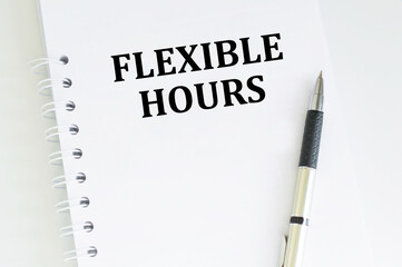 FLEXIBLE HOURS text on a notepad with pen, business