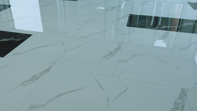 Big flooring tiles installed in beautiful home, tiles are made of ceramic material and with marmoreal textures . Granite or Marble floor .