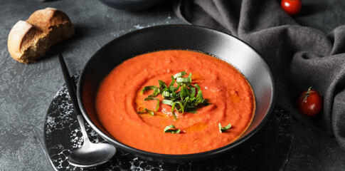 Bowl of tomato cream soup on table