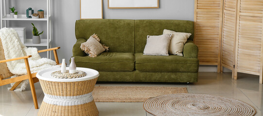 Interior of living room with rattan table, armchair and sofa