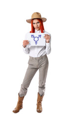 Stylish transgender woman holding paper sheet with transgender symbol against white background