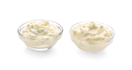 Delicious Caesar sauce in glass bowls on white background