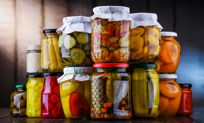 Jars with variety of marinated vegetables and fruits