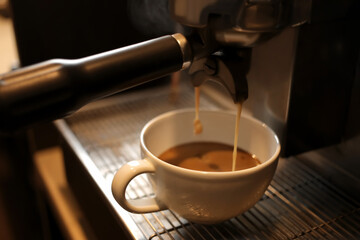 Coffee machine preparing hot espresso in cafe