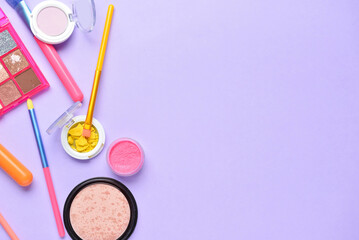 Naklejka premium Set of makeup brushes and different decorative cosmetics on color background