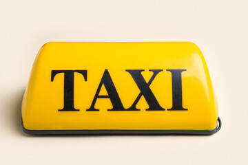 Yellow taxi roof sign on beige background