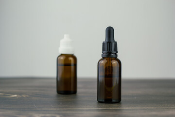 different essential, cbd oil or organic cosmetics brown glass bottle with pipette.