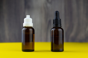 different cbd oil or organic cosmetics brown glass bottle with pipette.