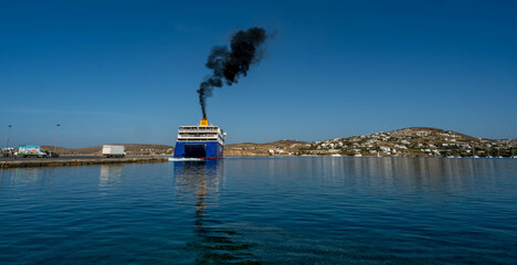 Plume of black smoke from a ferry boat at Paros island - obrazy, fototapety, plakaty