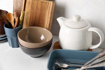 Set of different dishware and kitchenware on white table