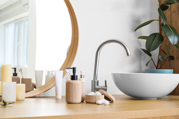 Fototapeta premium Table with modern sink and bath accessories near white wall, closeup